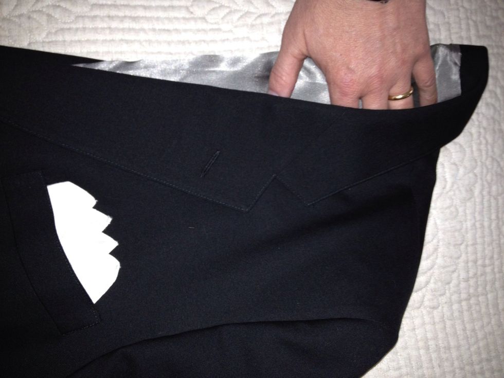 Slide your hands inside lapels and smooth out any creases in jacket lining.