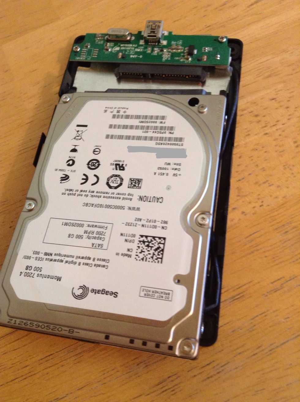 Slide your hard drive into the case lining up the pins.