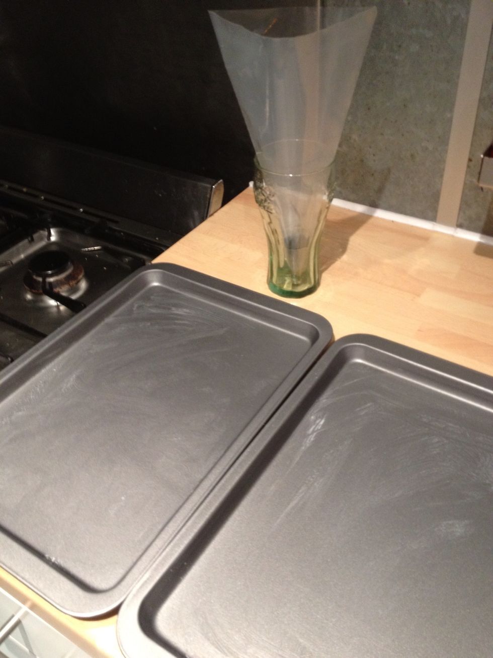 Slightly grease two baking sheets. Measure out 100ml of water and put a separate baking tray in the oven. And put the piping bag with a round nozzle ready to use.