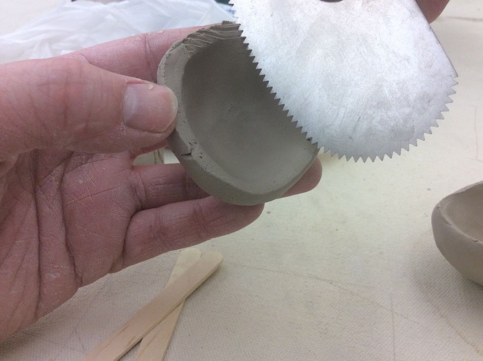 Slip and score the pinch pots together.