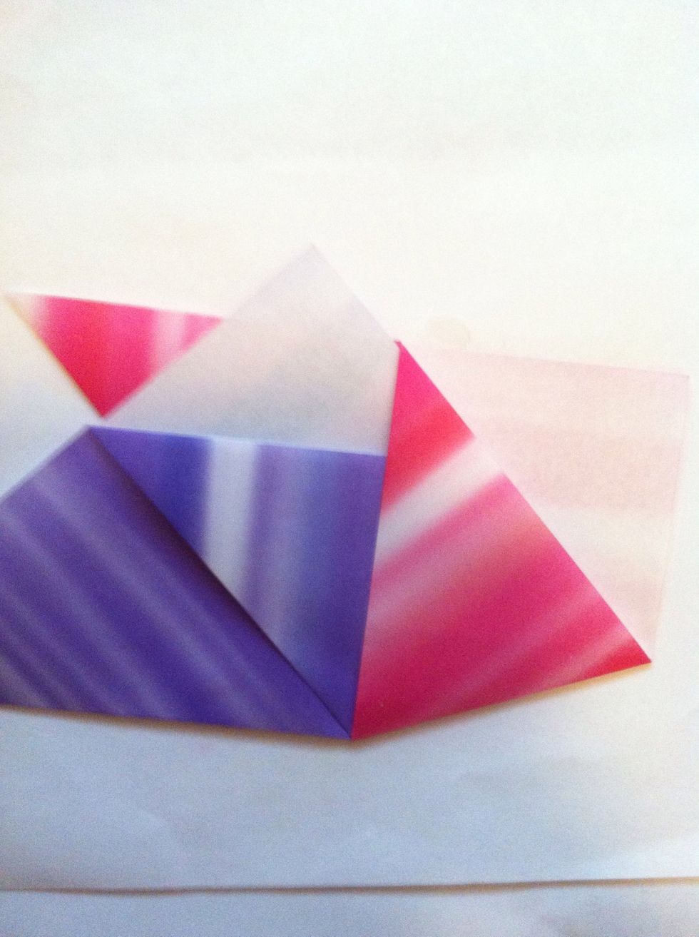 Slip one into the other. In this case, purple is going into the pocket of the pink one. The bottom tip of the purple will be just barely in that pocket.