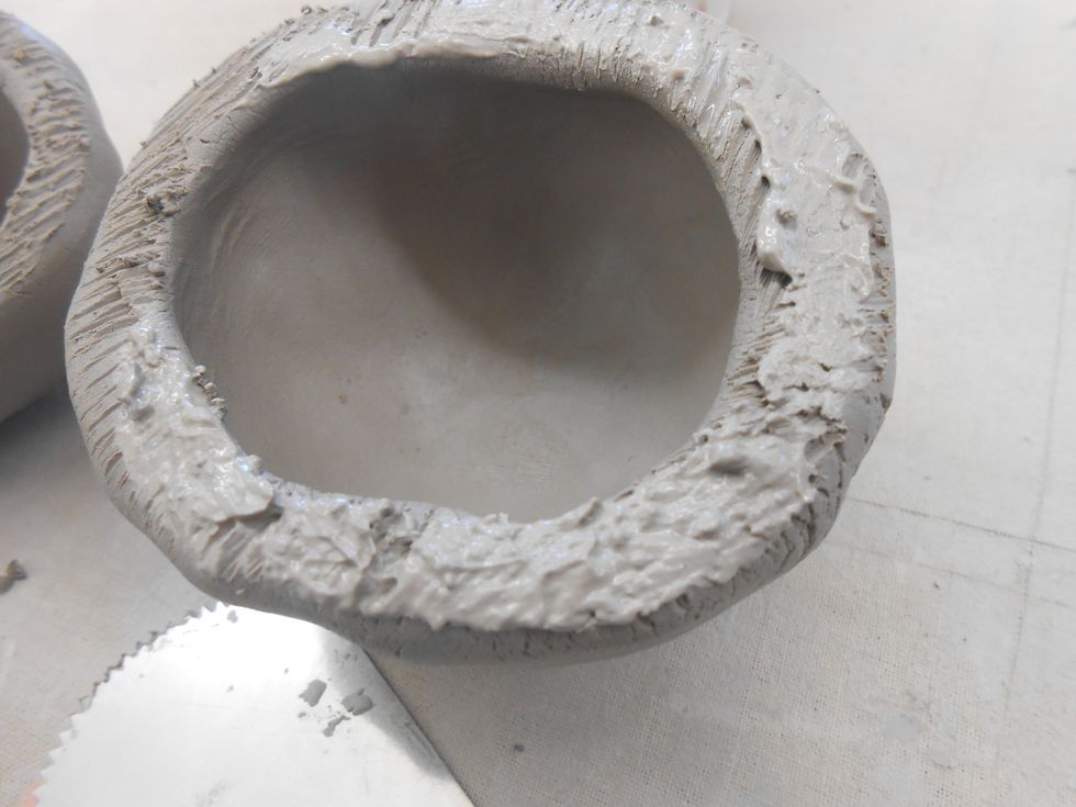 slip one of the pinch pots so you don't have slip oozing out