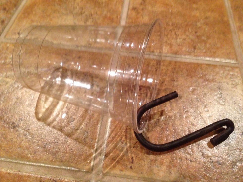 Slip the hook through the hole.  Repeat for all the cups and hooks that you will need to store your nail polishes.