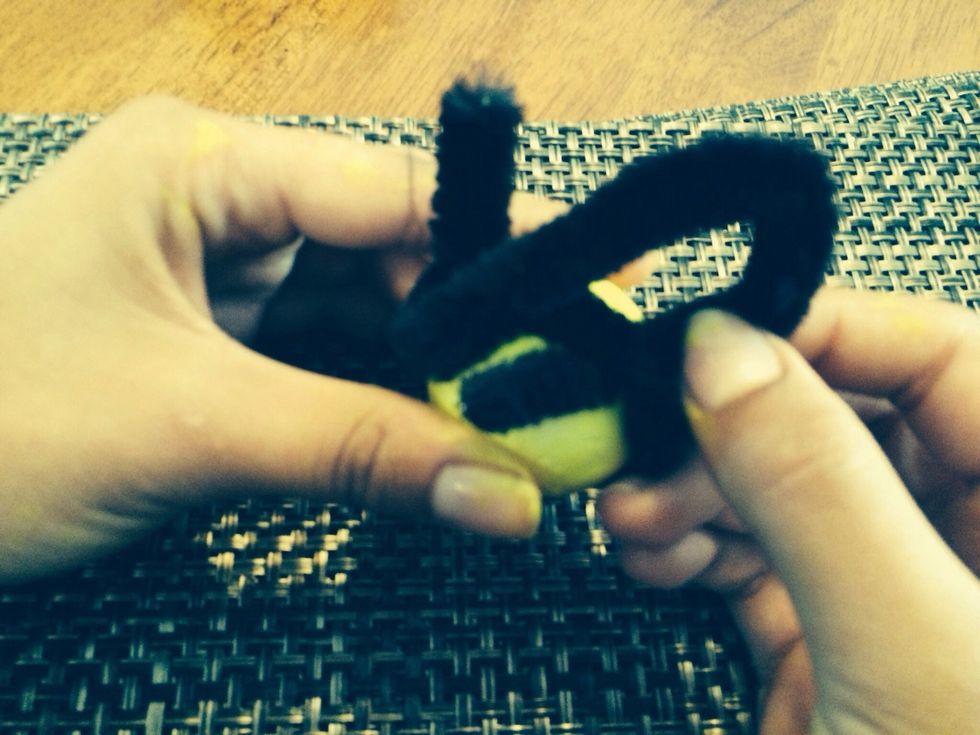 Slip the part you just wrapped around between the pipe cleaner and ball.