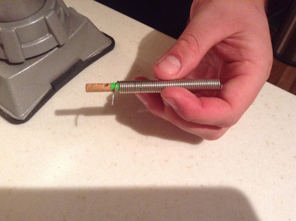 Slip the rod into the coil or twist it in like a screw. The rod will keep the rings in place while they are being cut.