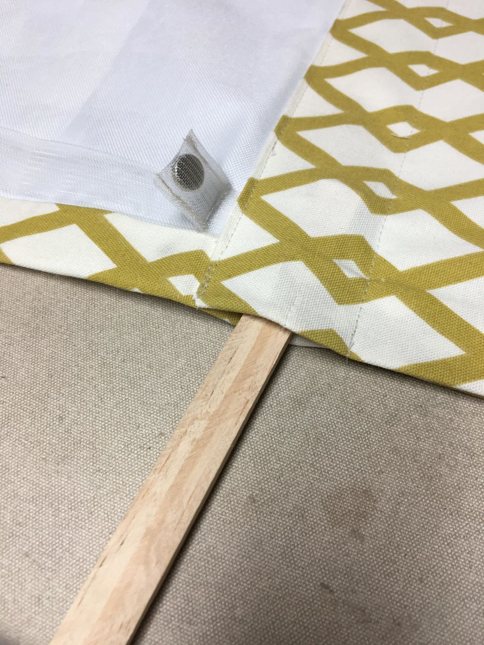 Slip the wood strip or weight bar right into the pocket. This keeps the bottom of the shade from sagging.