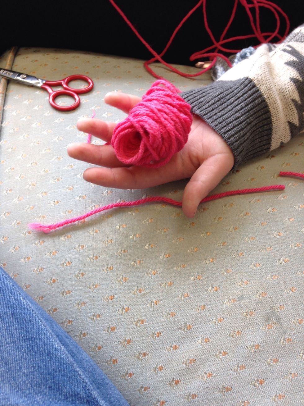 Slip the yarn off your finger and cut a piece of yarn about 6 inches long