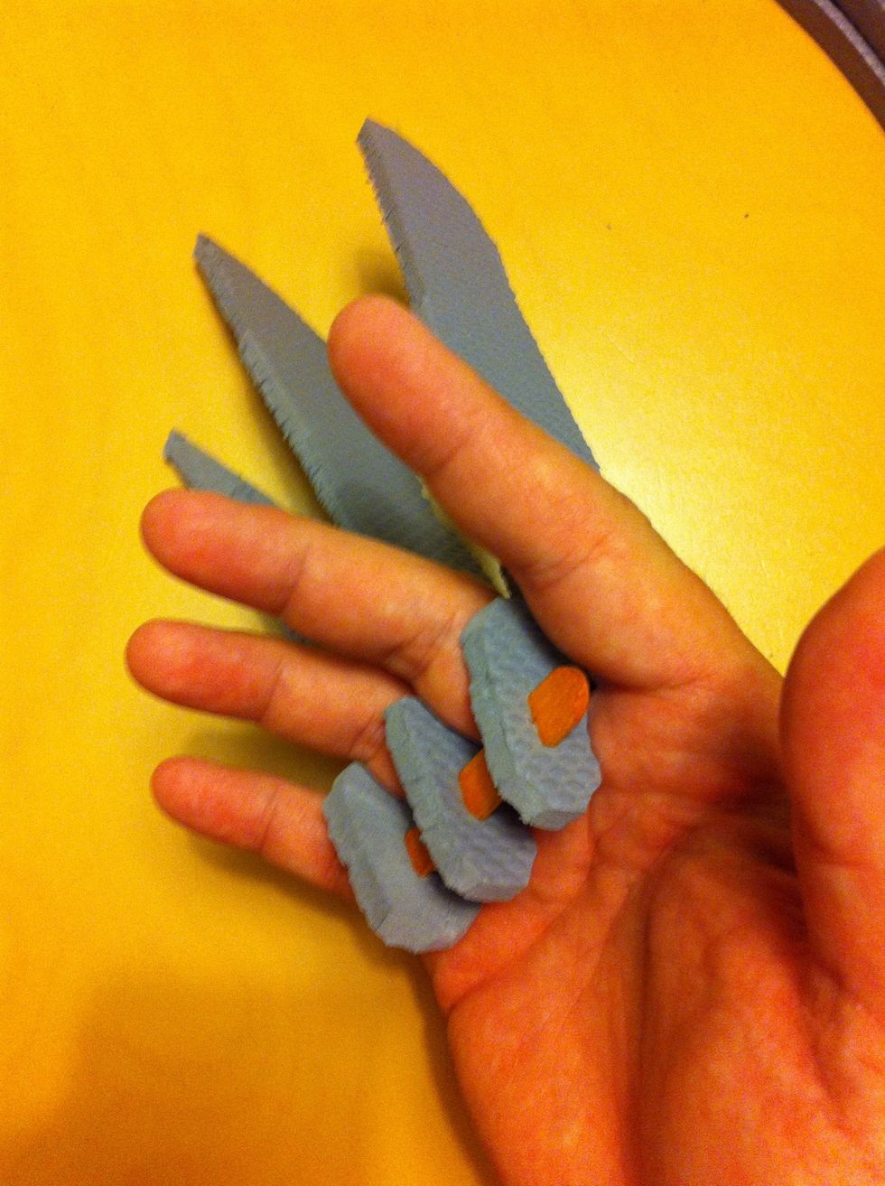 Slip your fingers between the claws, with the Popsicle stick in your palm. The tension will hold the claw in place.