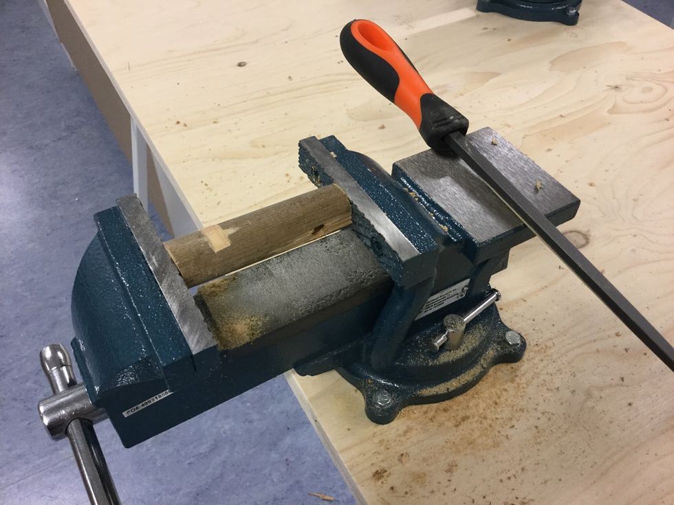 Slipa en likadan sk\u00e5ra i den l\u00e5nga delen. Sk\u00e5ran ska vara p\u00e5 motsatt sida om h\u00e5let som inte g\u00e5r rakt igenom rundstaven.