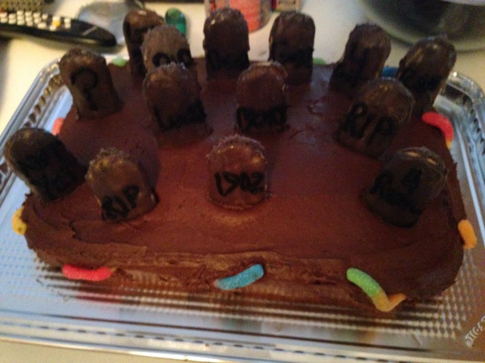 Slit some holes in the side and stuff in some gummy worms and place the gravestones on top