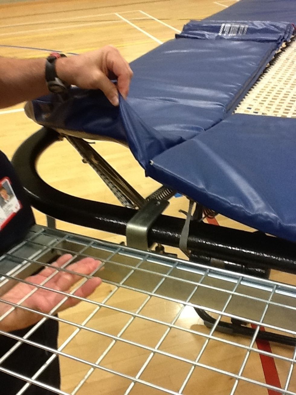 Slot the brace onto the frame of the trampoline. Secure the brace with the screw provided.