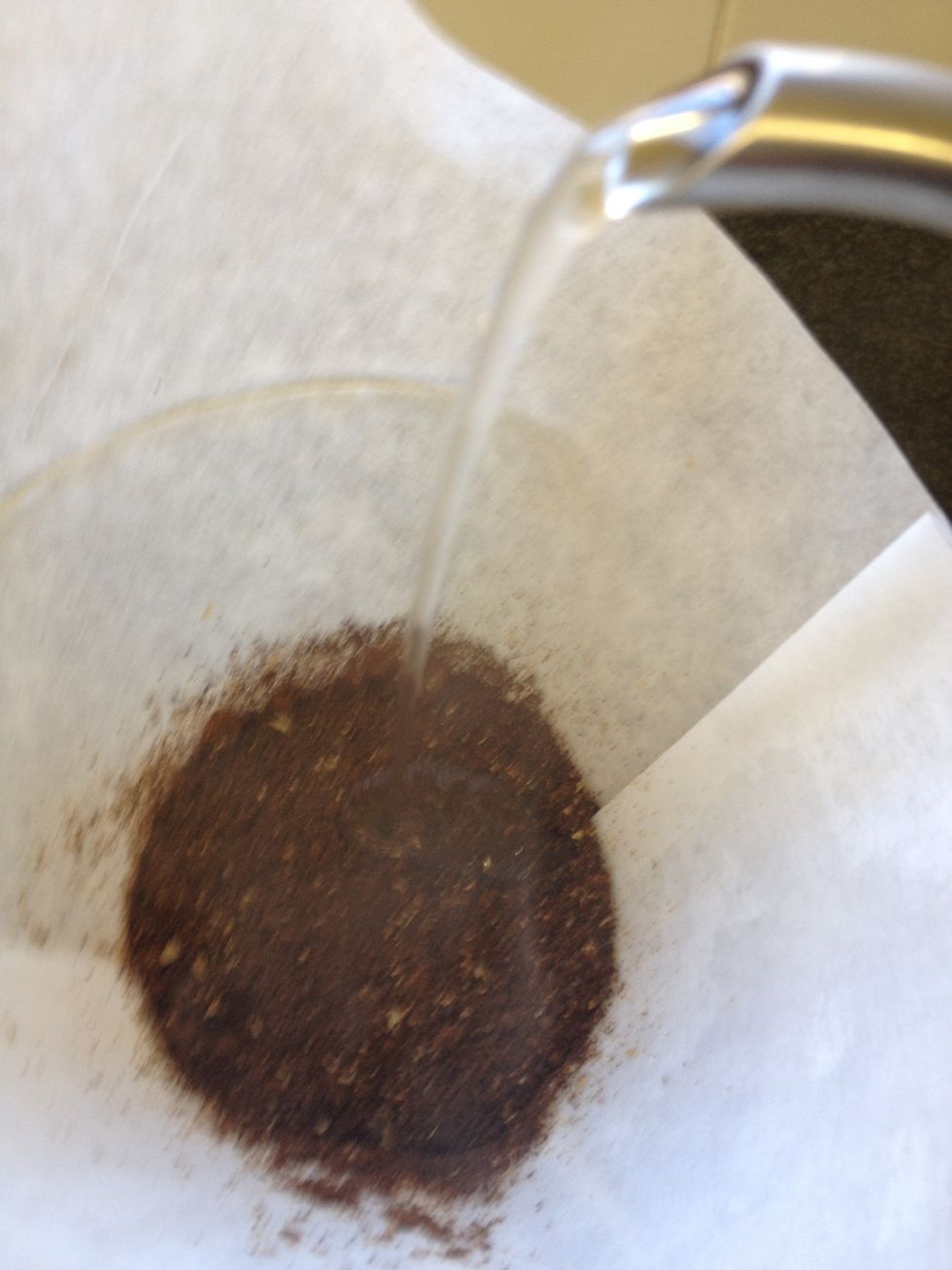 Slowly add 60g of the 90 deg C water to the grounds. This will start the bloom which is essential for a full flavoured cup.