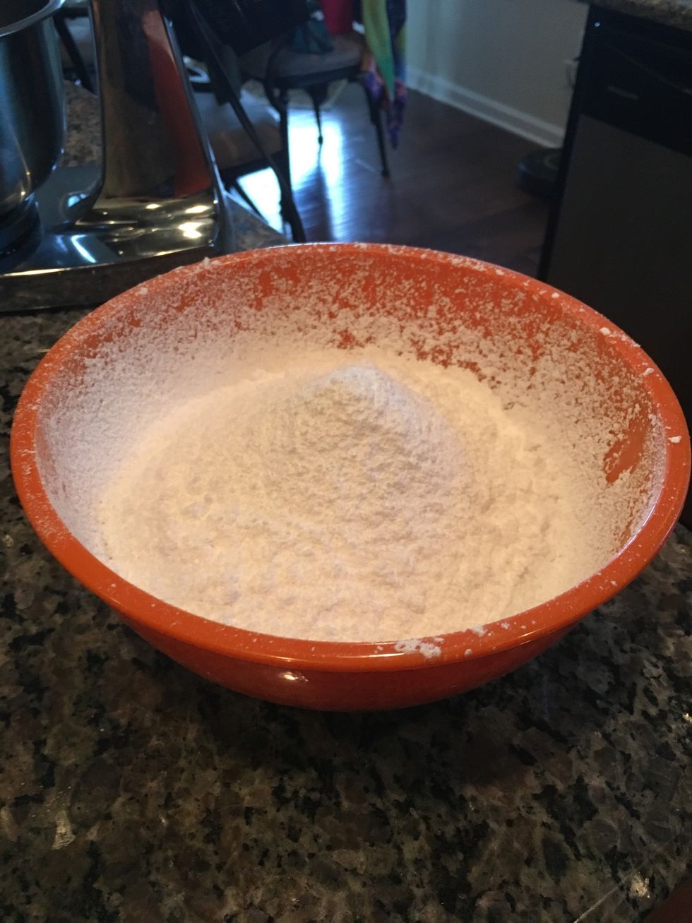 Slowly add in the sifted powdered sugar into the mixing bowl.