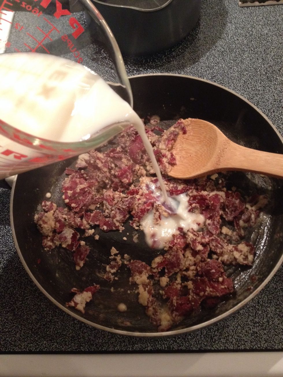 Slowly add milk, stirring constantly.