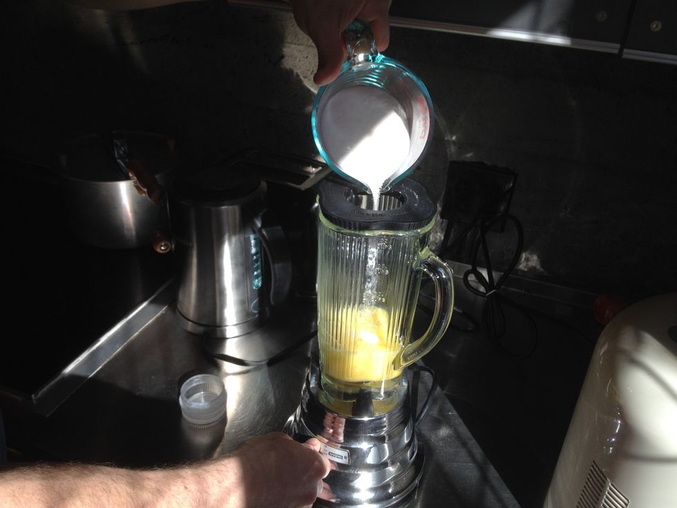 Slowly add sugar and mix, ensuring it has had time to blend in before pouring the next bit.