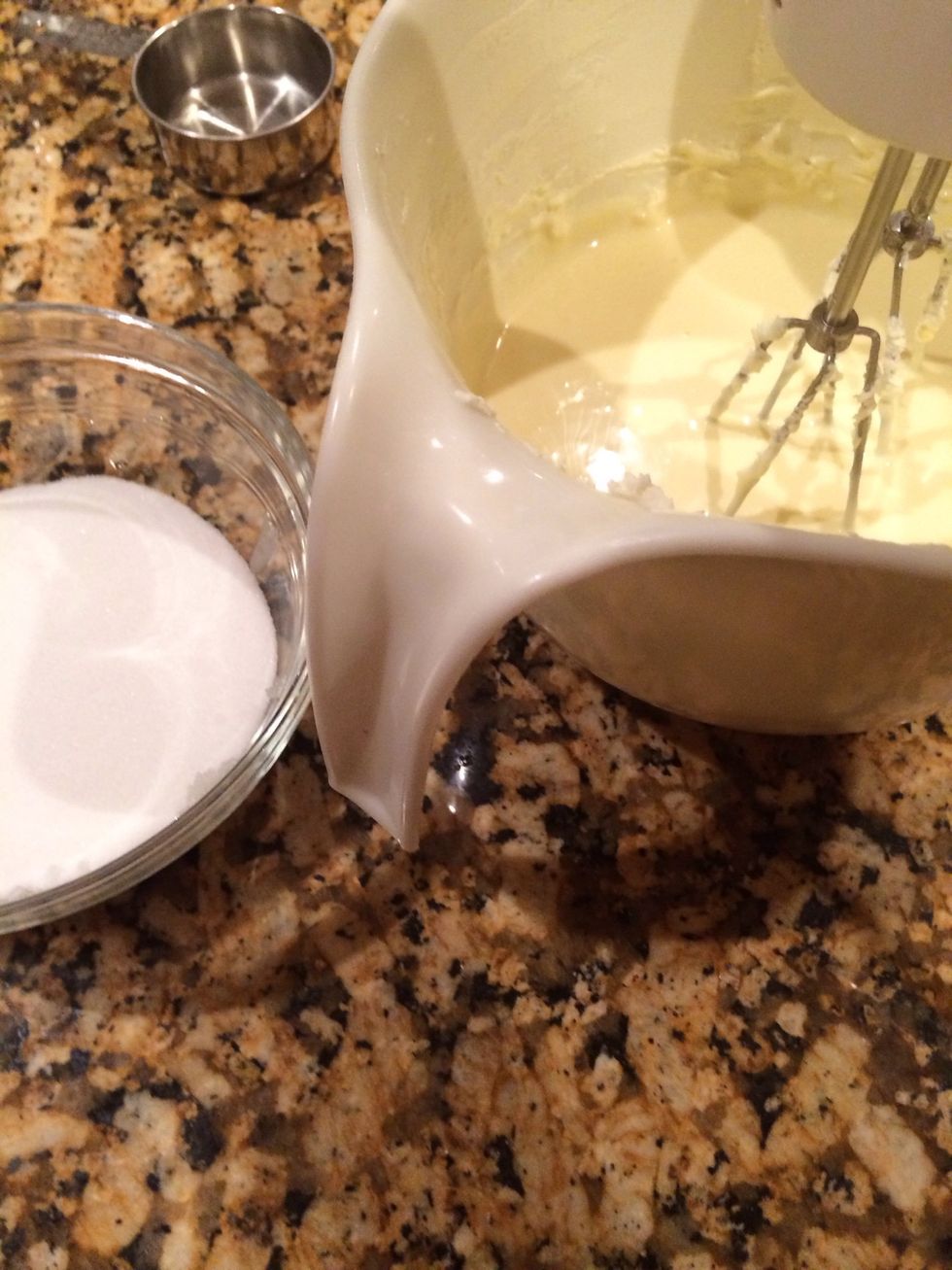 Slowly add sugar while mixing