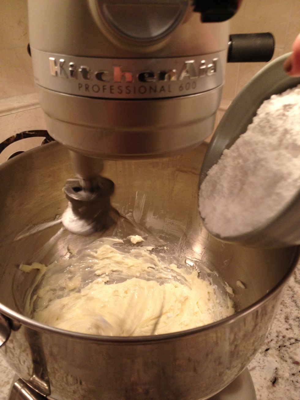 Slowly add the confectioners sugar while mixing.