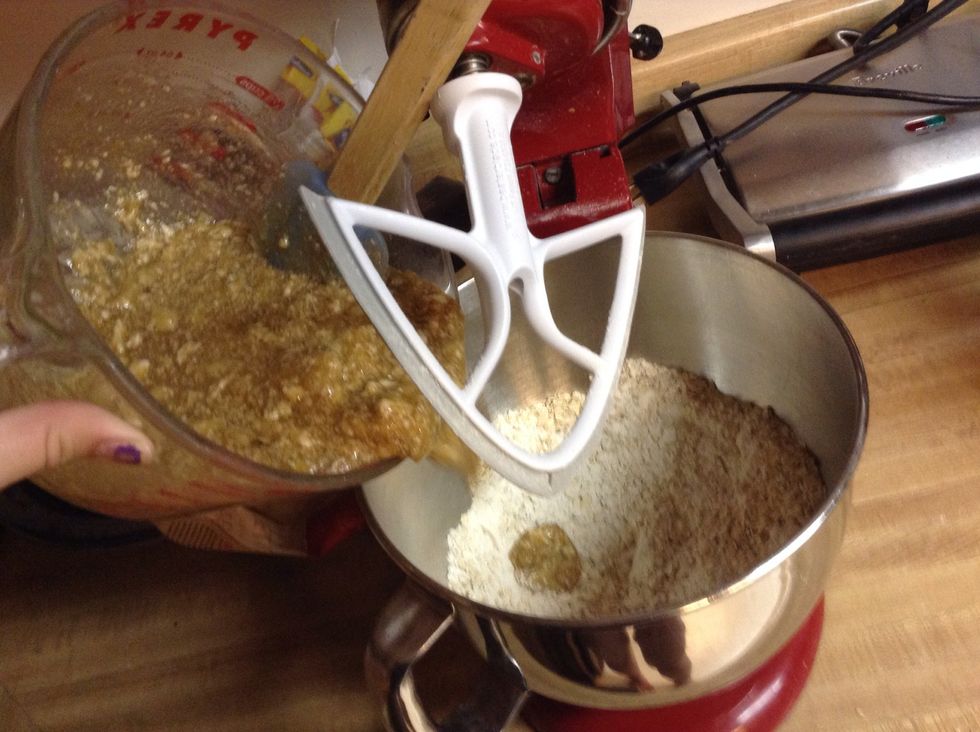 Slowly add the wet ingredients to the dry ingredients and mix them together.