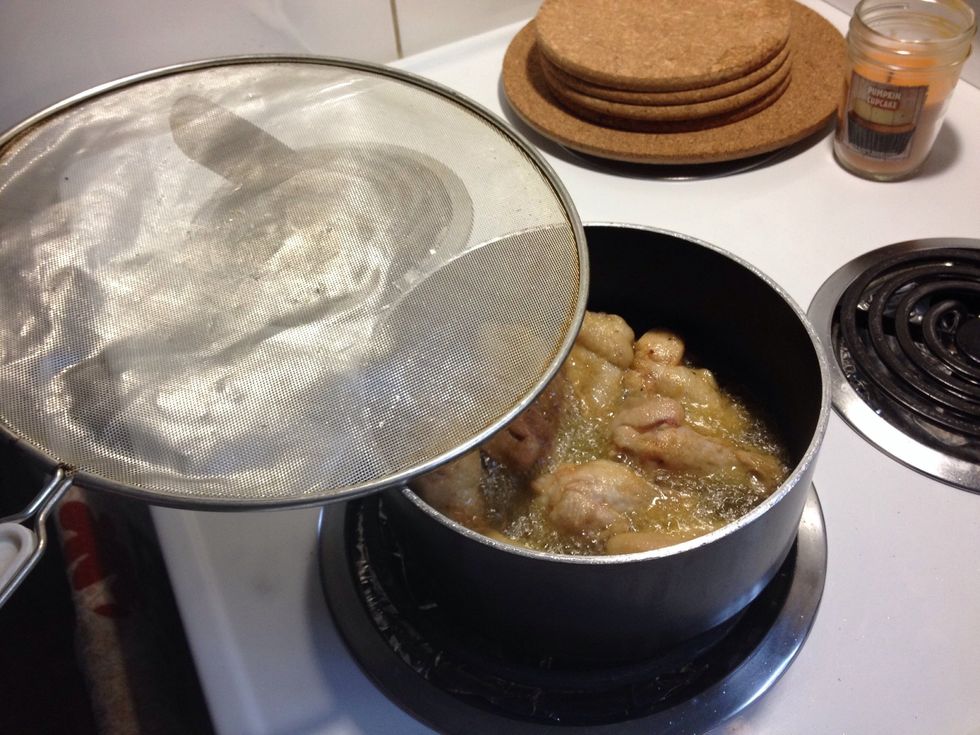 Slowly add wings well assessing the heat of the oil. Adding more wings the 1/4 full pot should raise to 1/2 full well still providing a level of safety. Cook for 8 to 10min or more for more crunch.