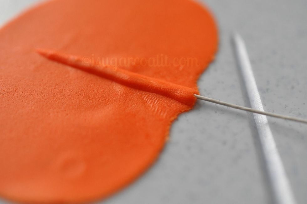 Slowly and carefully insert the wire into the ridge, using your fingers to guide the wire.