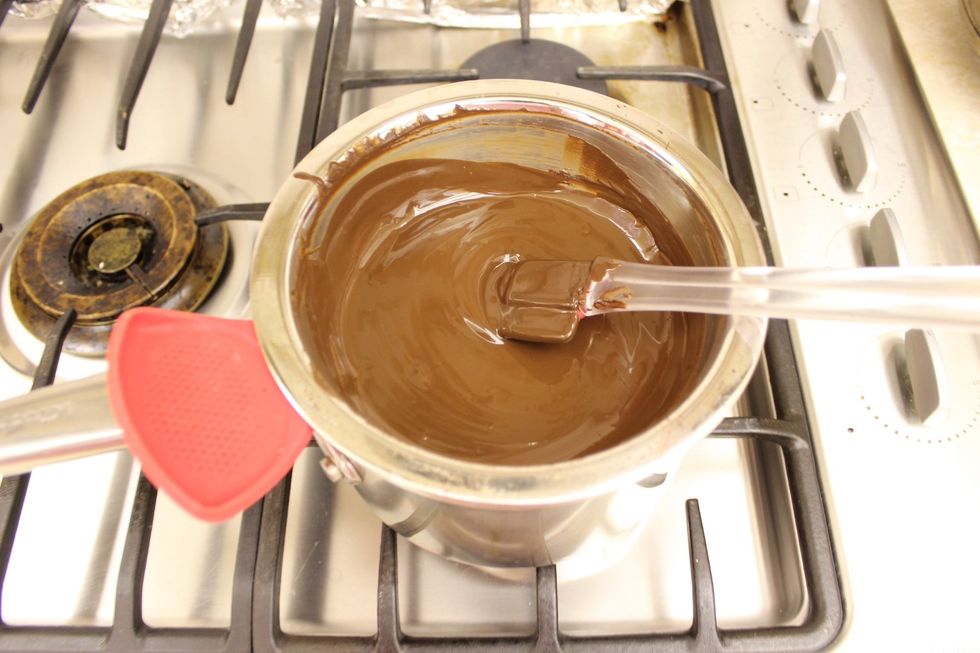 Slowly and evenly melt the chocolate over simmering heat. Ensure that you are constantly stirring the chocolate so it doesn't burn. Remove from heat as your last couple chocolate chunks melt.