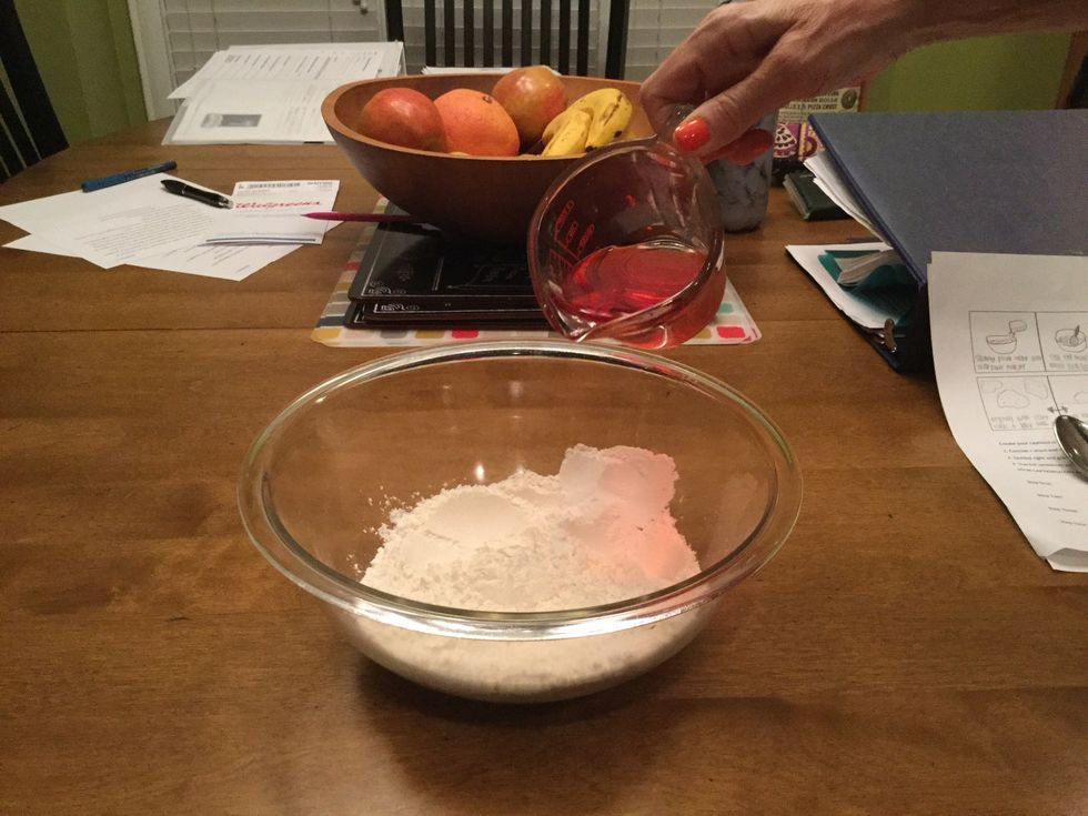 Slowly and evenly pour the water and food coloring into the flour/salt mixture.