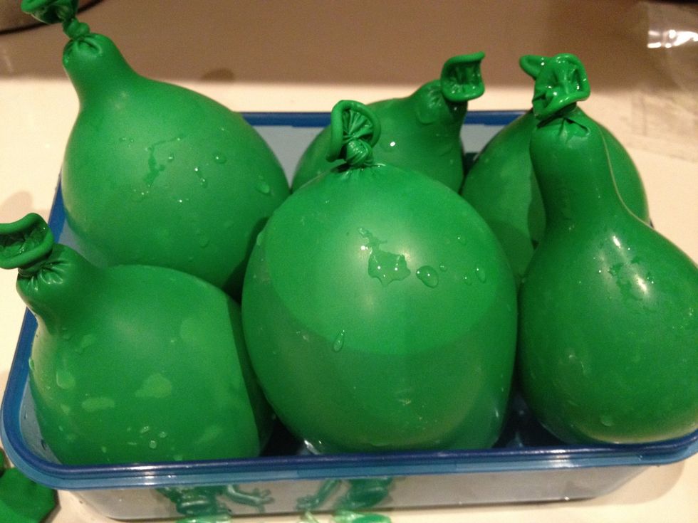 Slowly fill balloons in the same way, trying to keep them a similar size. I put mine into a dish to stop them rolling around, but they hold a better shape when placed into the freezer individually.