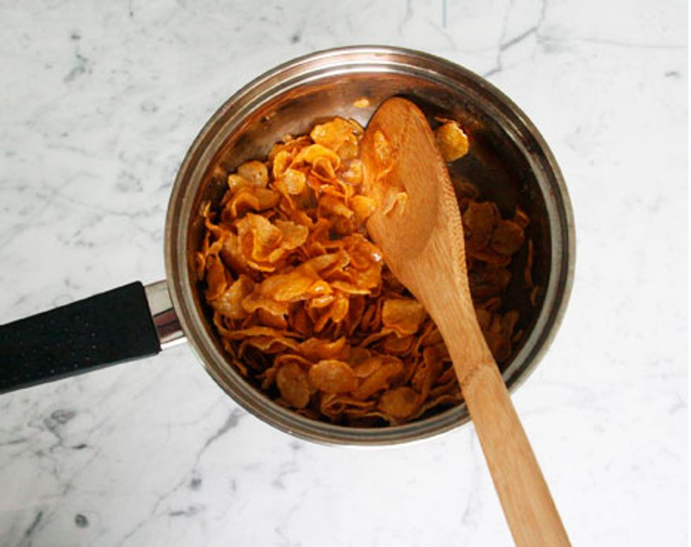 Slowly mix in cornflakes and stir together. Make sure all the cornflakes are covered generously with the mixture.