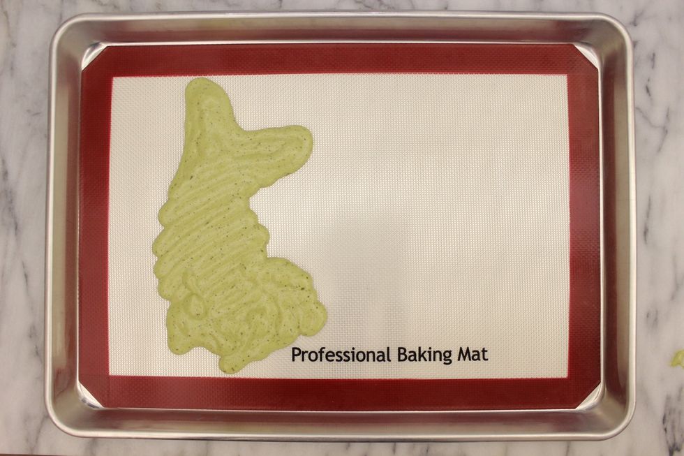 Slowly pipe the cake batter over your design. Make sure you get into every nook and cranny of your design.