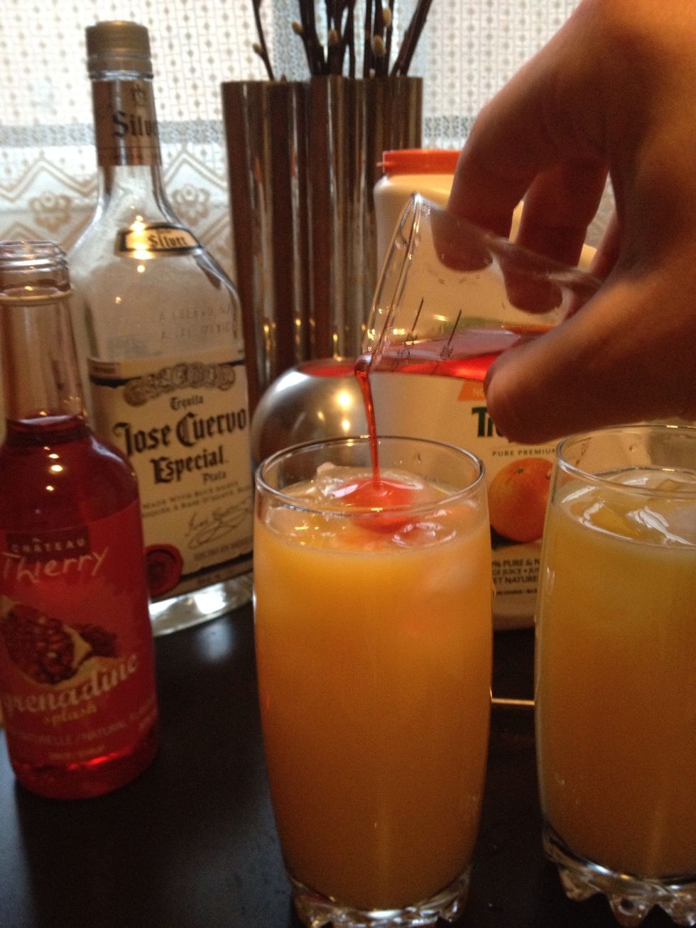 Slowly pour 1/2 Part of grenadine, don't stir or shake, when you start drinking it will mix slowly itself