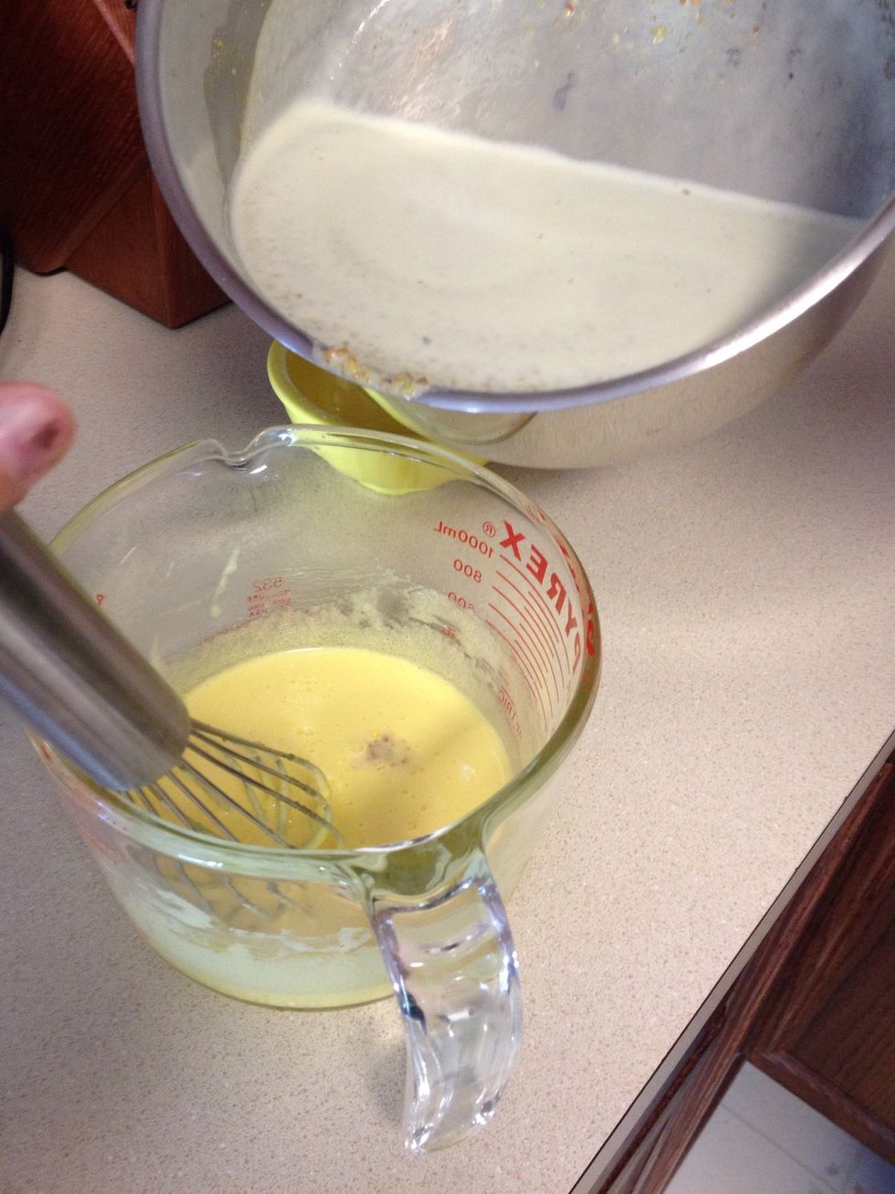 Slowly pour the milk into the eggs while whisking vigorously