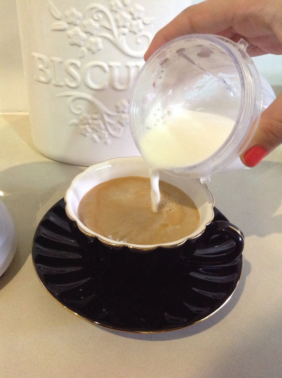 Slowly pour the milk into your coffee.