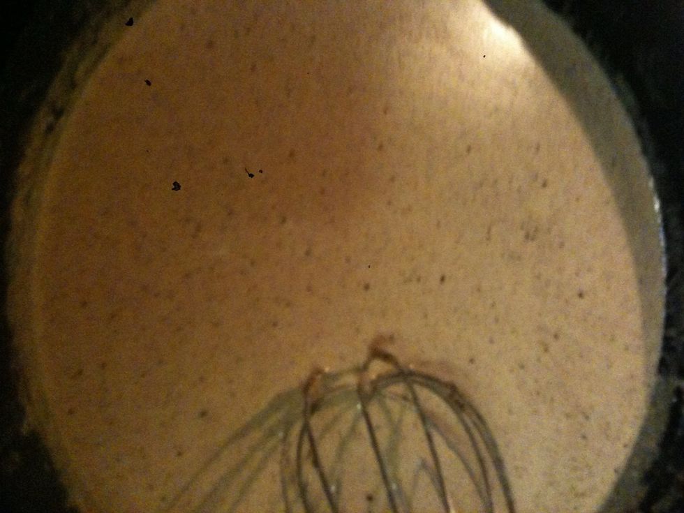 Slowly start to whisk in 2 cups of milk start slow so when the milk starts to combine with the flour mixture it doesn't form clumps