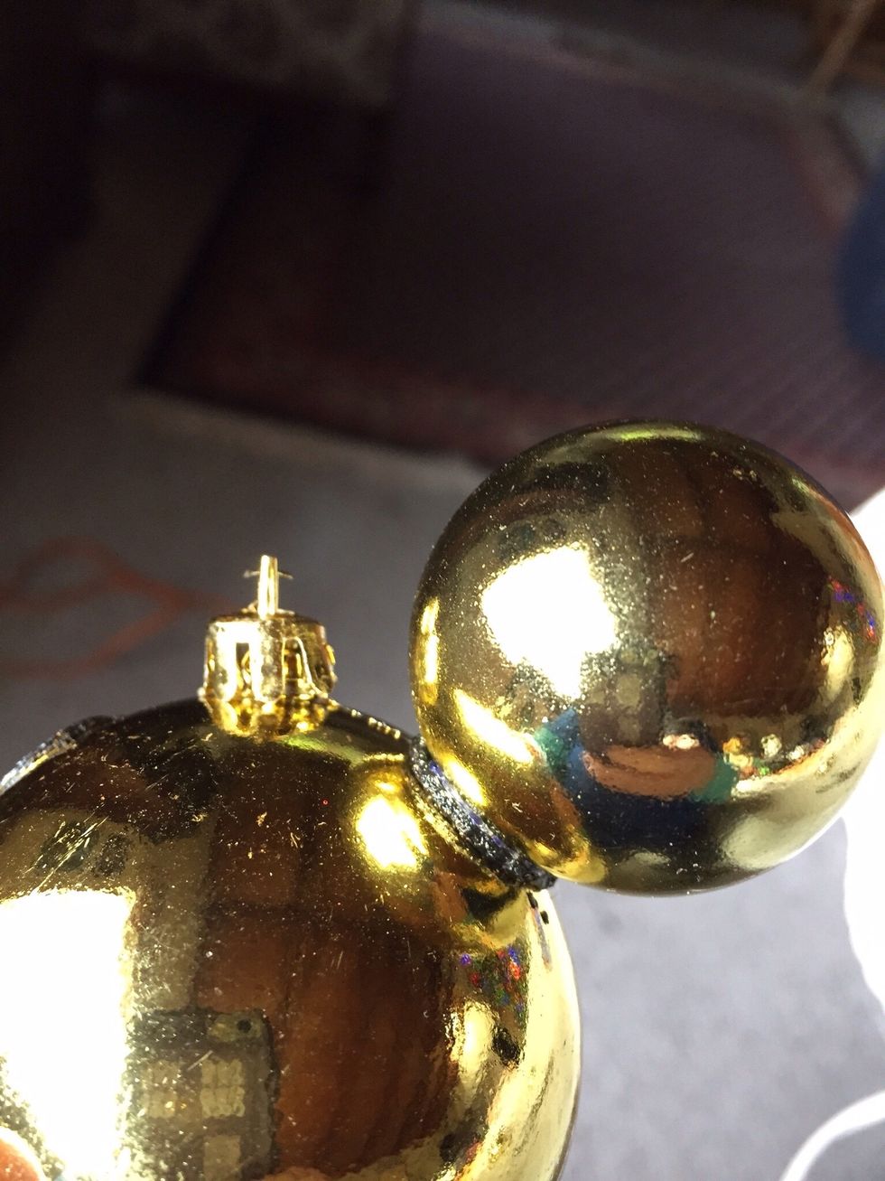 Slowly twist smaller ornament into hole until it is flush with bottom of hole.