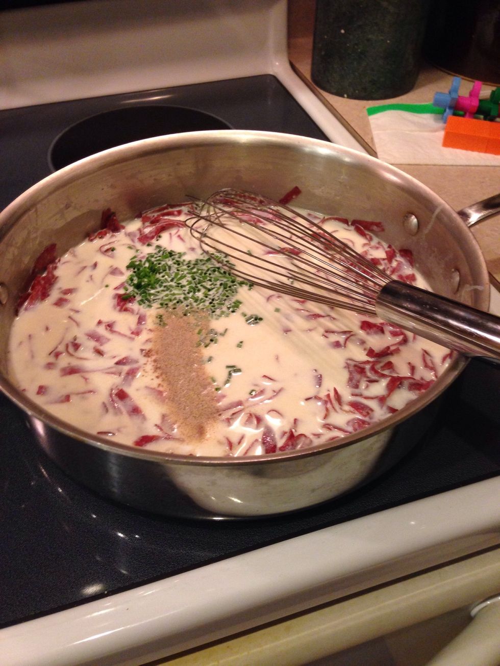 Slowly whisk in the warmed milk & half and half, pepper, chives, and nutmeg. Continue cooking, stirring constantly, until thickened and creamy but still pourable, about 5 minutes.