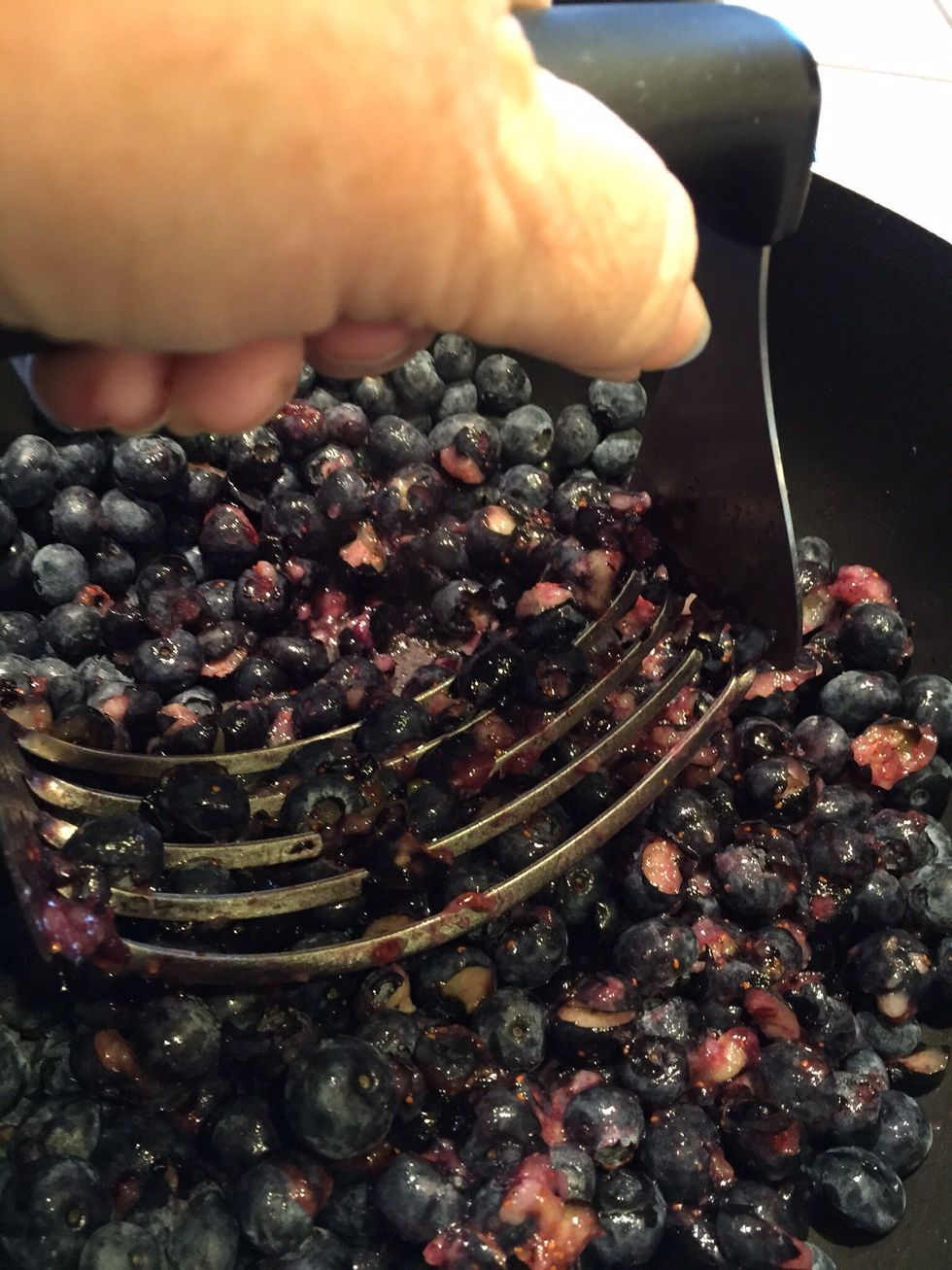 Smash berries. (Wearing an apron is a good idea so you do not get speckled with blueberry juice.)