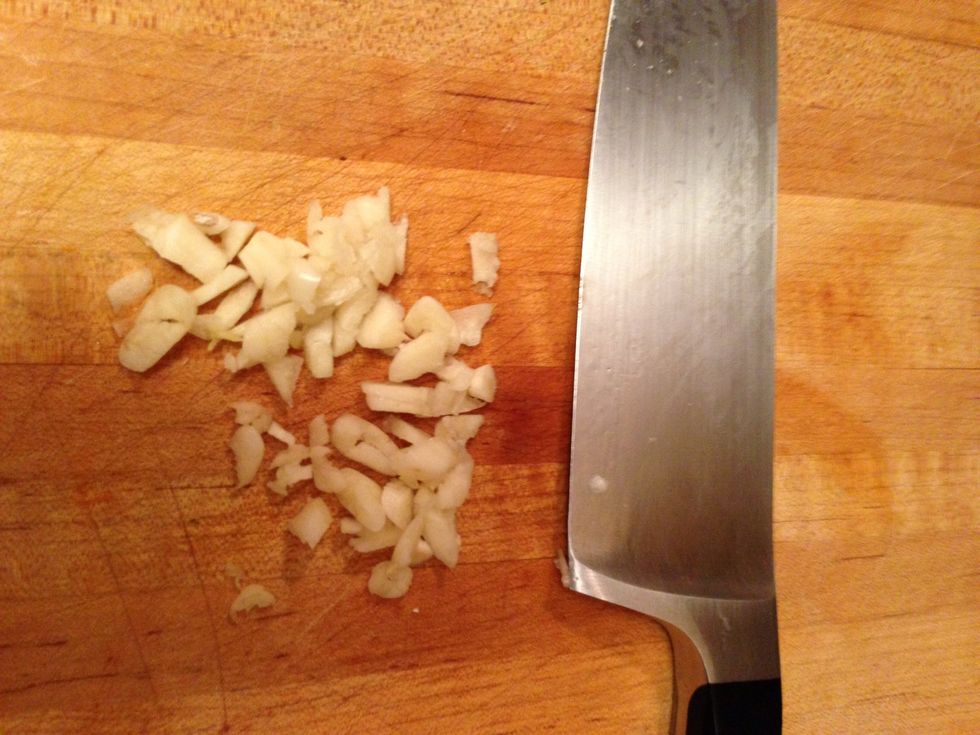 Smash, peel and chop the garlic cloves.
