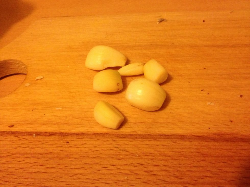 Smash the garlic cloves. Add them too.