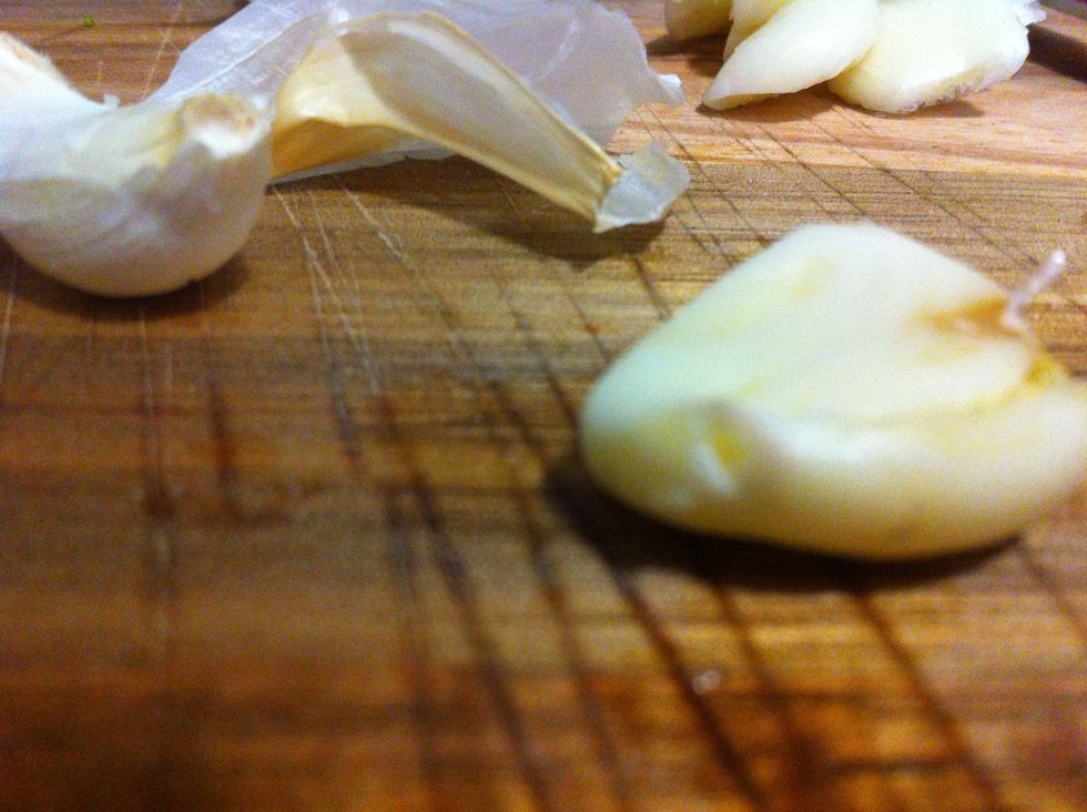 Smash your garlic by placing the flat side of your knife directly in top of a clove of garlic and pressing down on it with the palm of your hand