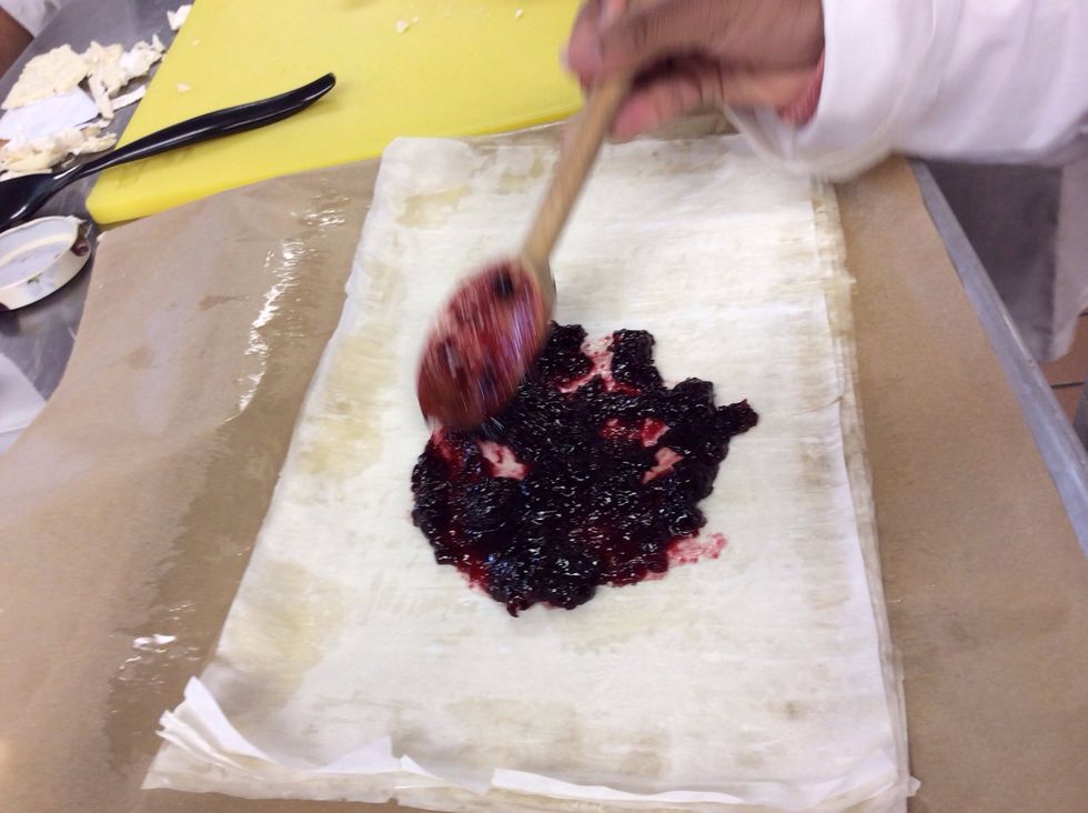 Smear 2 cups of cherry preserves on your layers of phyllo dough in the middle