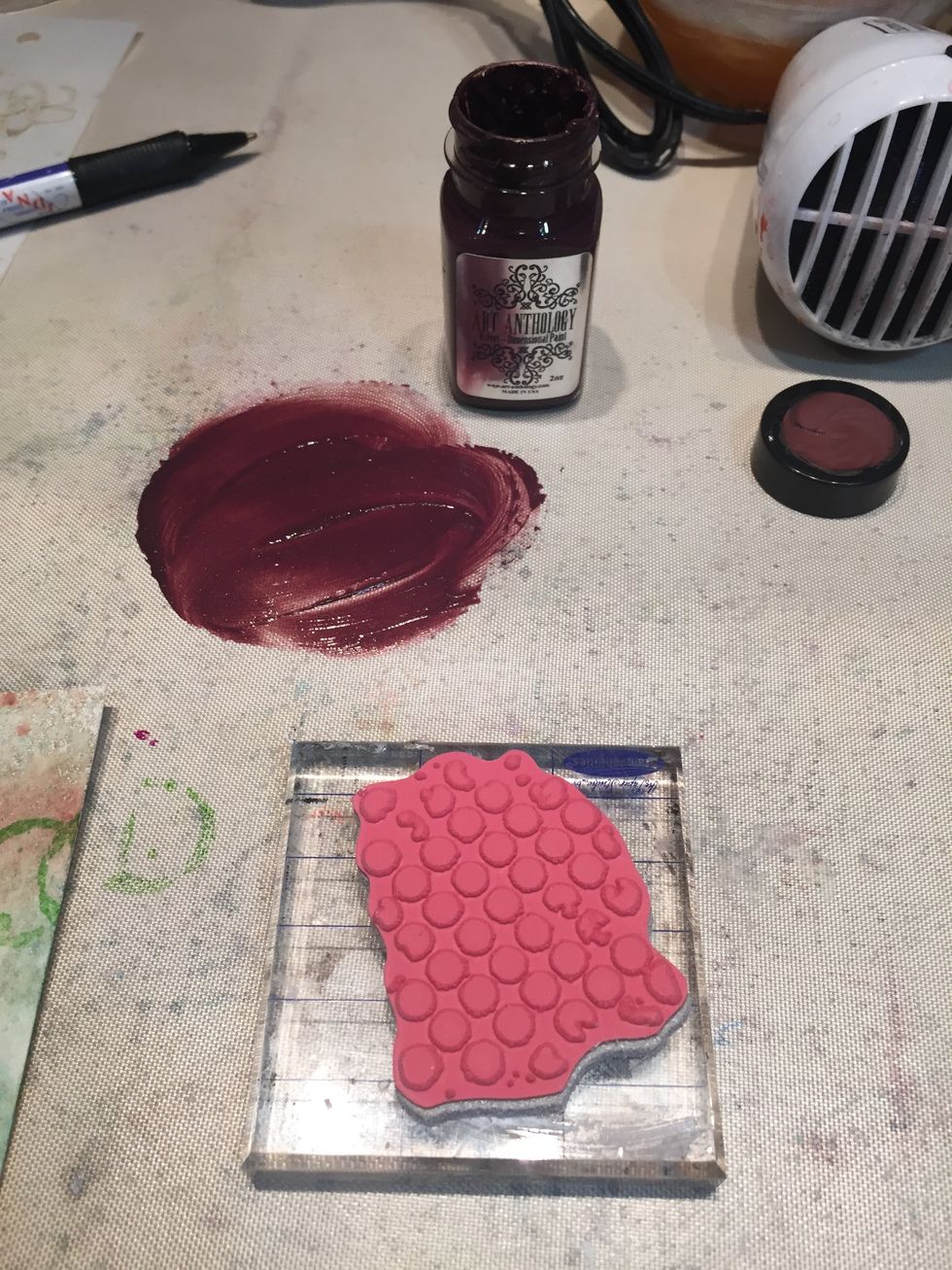 Smear some Truffle Velvet on your mat and stamp into it. Stamp your paper randomly. Make sure you wash your stamp immediately after using it with paint.