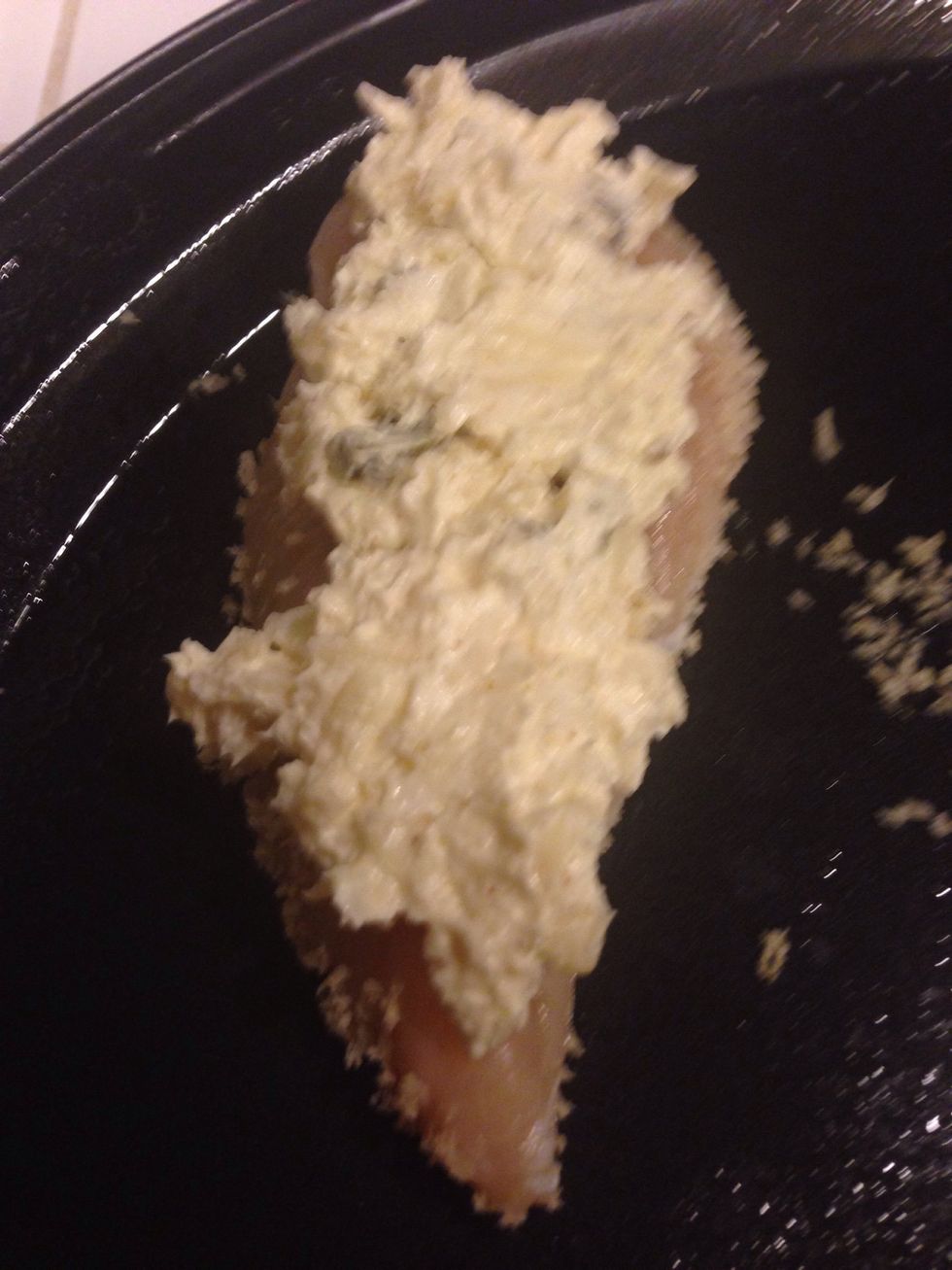 Smear two tablespoons of your popper mixture on the chicken.