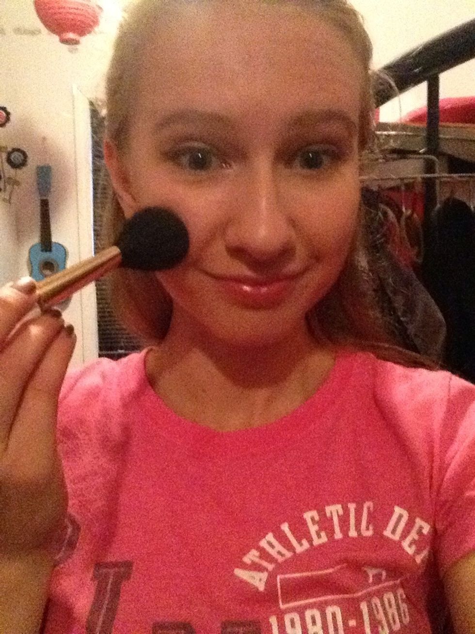 Smile and add the blush from the apples of your cheeks and blend it up into your temples.