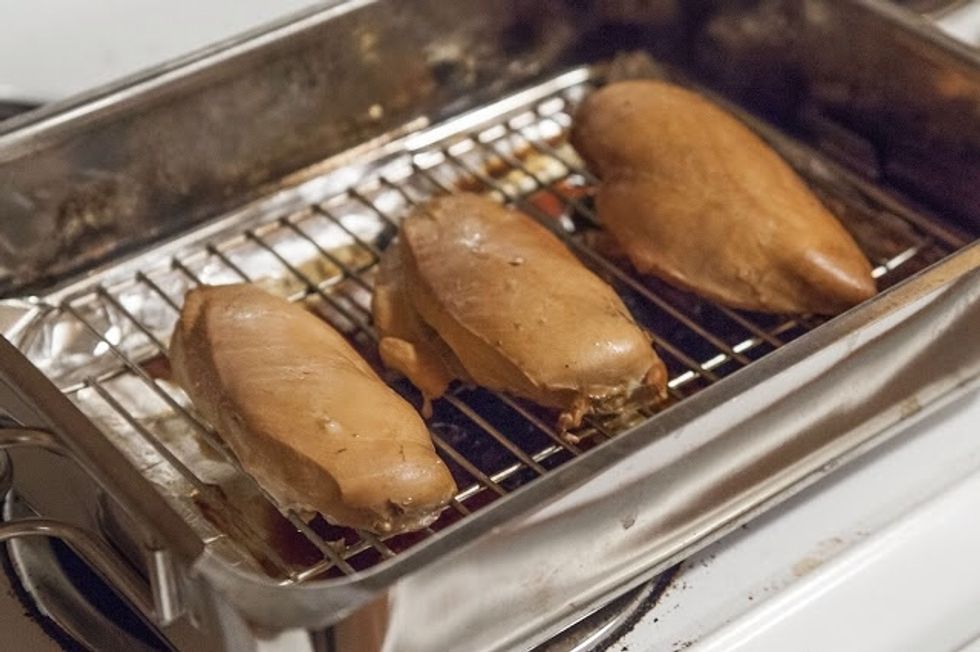 Smoke the chicken for about 30 minutes. Check the temperature with a meat thermometer. When it reads 165 degrees, it's done. Wrap them in tinfoil and let them rest for 5 minutes before slicing them.