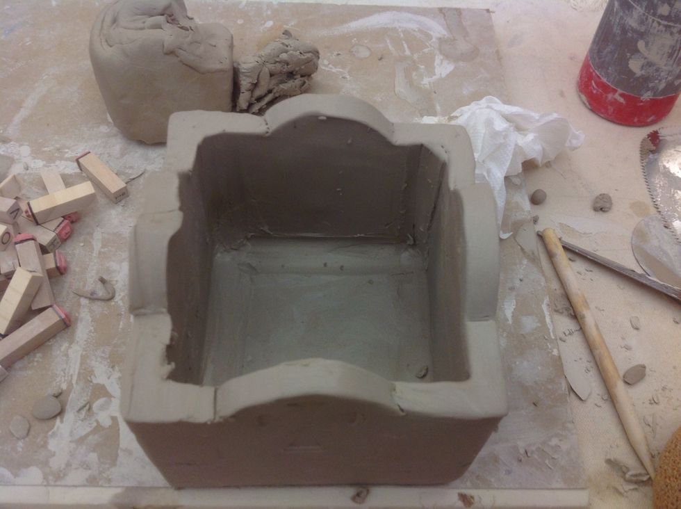 Smooth all the edges with a sponge. Be careful not to change the shape so the lid fits back on.