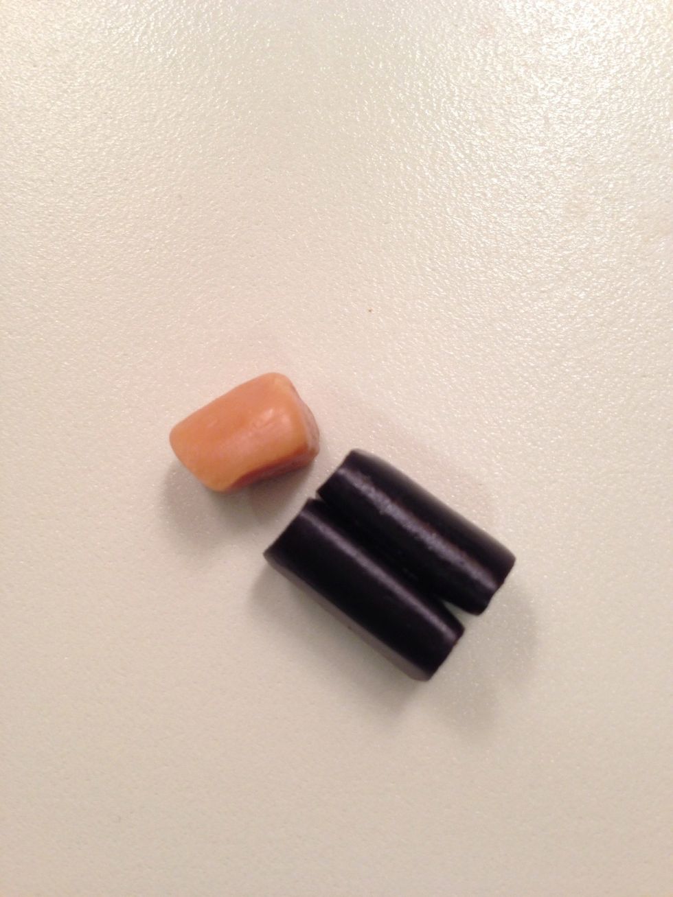 Smooth the caramel a little with your fingers and stick it to the licorice with some chocolate. A tiny bit if shortening on your finger tips will help with stickiness.