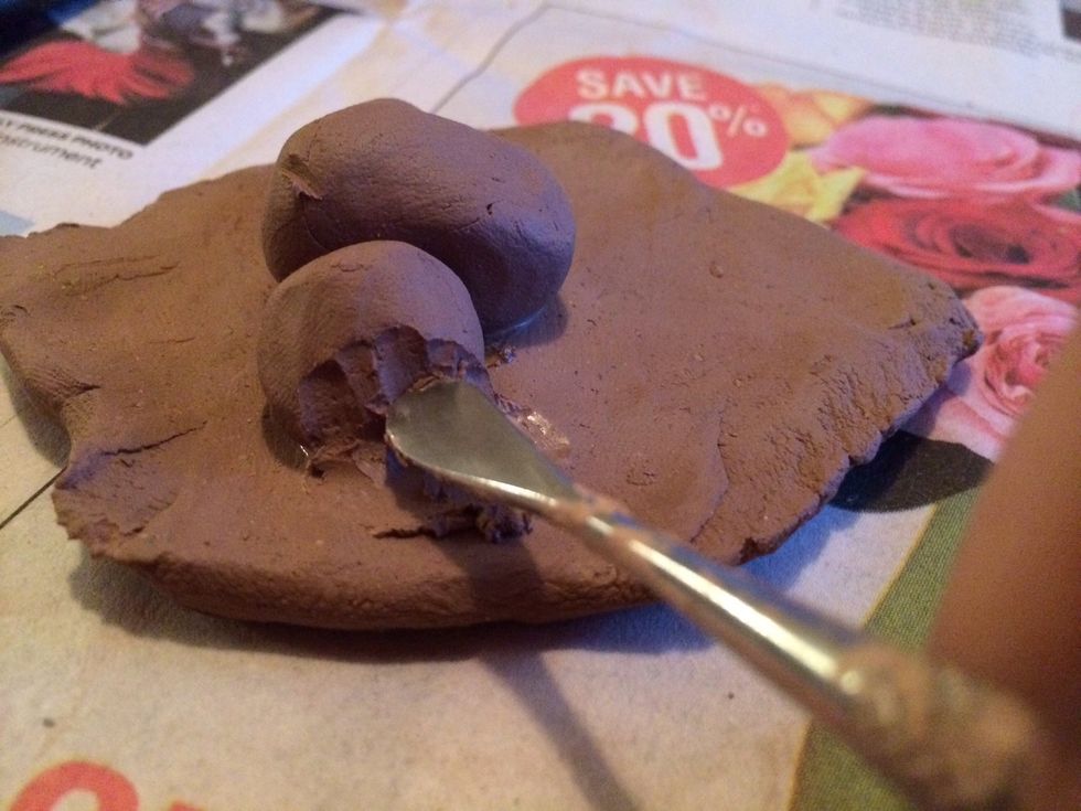 Smooth the edges of the added clay so that the clay appears to be one piece.