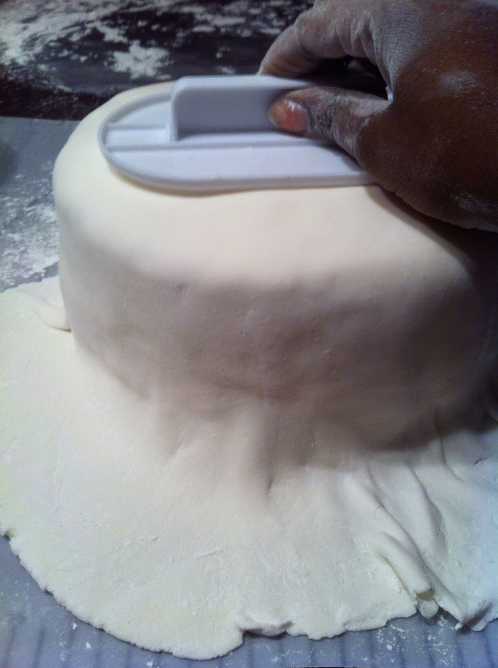 Smooth the fondant with a fondant smoother. This little thing really works.