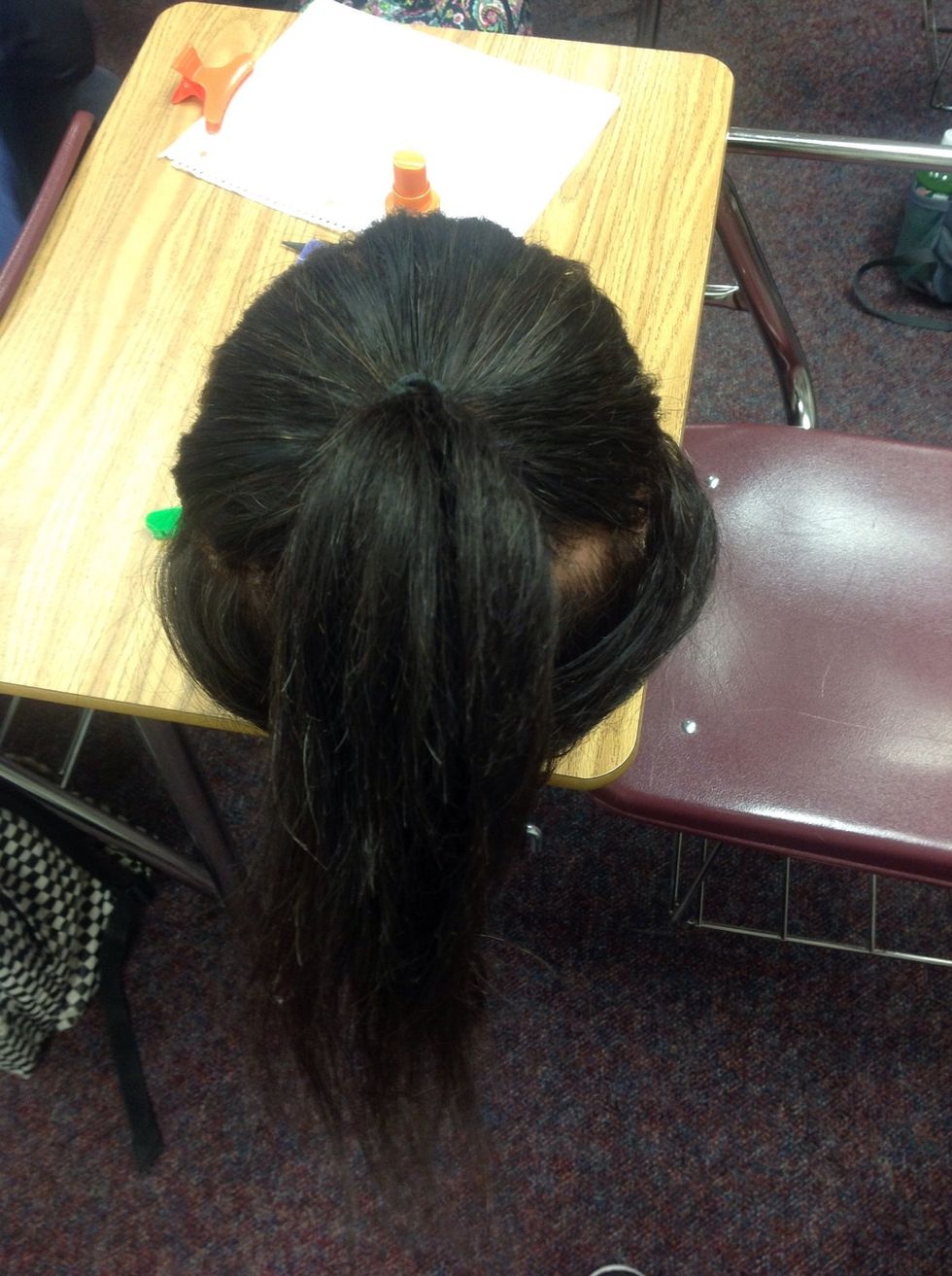 Smooth the sectioned hair into the pony tail