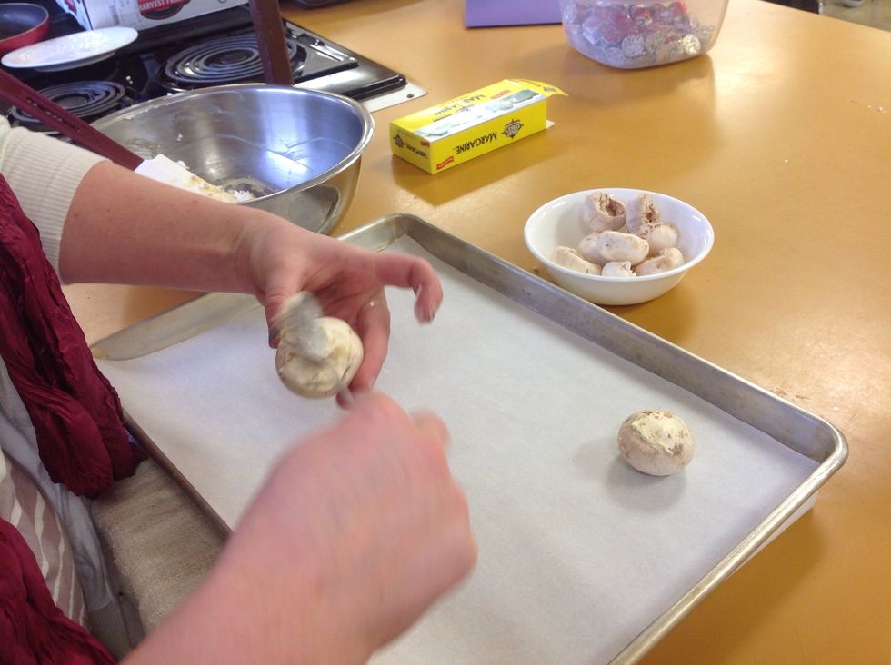 Smoothing out the top with the spoon.